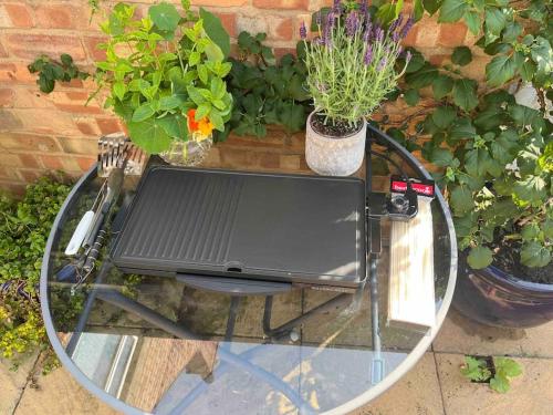 a glass table with a tv on top of it at Field View in Oakham