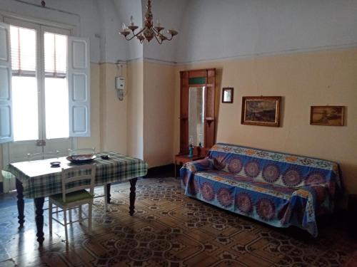 a living room with a couch and a table at Casa Paola in Cutrofiano