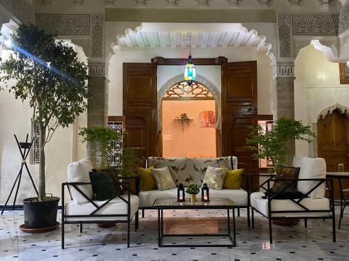 a living room with a couch and two chairs and a table at RIAD LALLA ZINEB in Rabat