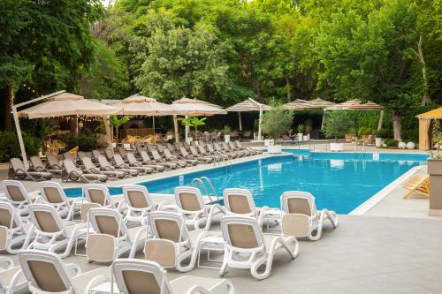 a group of chairs and a swimming pool at Best Western Plus Congress Hotel Yerevan in Yerevan