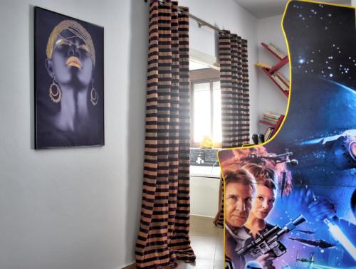 a room with a movie poster and a guitar at Home Apartments Jerez in Jerez de la Frontera