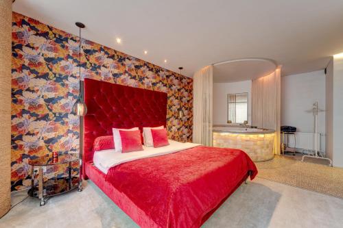 a bedroom with a red bed with a red head board at Apartments with jaccuzi in Vilnius