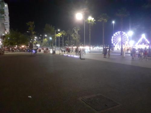 a large square with a ferris wheel at night at FA_HOLIDAYS in Vlorë