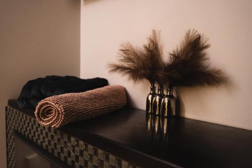 a black table with a vase with feathers on it at Apartments with jaccuzi in Vilnius