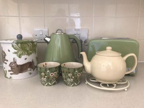 a kitchen counter with a tea pot and cups on it at No 96 Chapel Lane - Self Contained Cottage In The Heart Of Butleigh in Butleigh