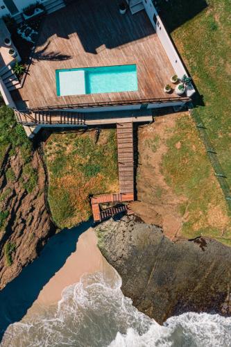an aerial view of a house on the cliff at Hotel Basalto in Punta Mita