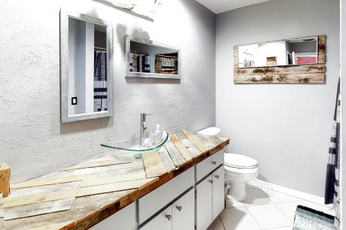 a bathroom with a counter with a sink and a toilet at Sundial Sanctuary in Fort Myers