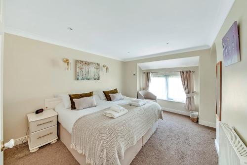 a bedroom with two beds and a window at Finest Retreats - Bilsdale Hall Cottage in Thirsk