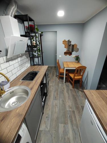 a kitchen and dining room with a sink and a table at Saules ieskauti in Saulkrasti