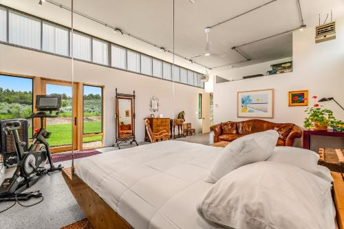 a large bedroom with a large bed and a living room at Paradise Place in Carbondale