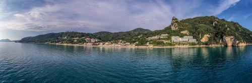 an island in the middle of a body of water at Elena's Seaside Apartments & Studios in Agios Gordios