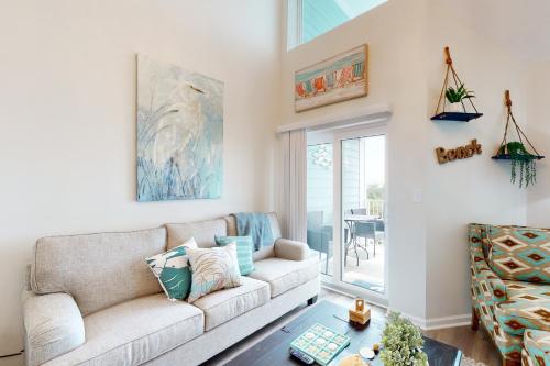 a living room with a couch and a table at Grand Caribbean #425 in Orange Beach