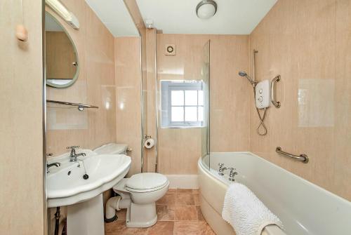 a bathroom with a sink and a toilet and a bath tub at Finest Retreats - Pennine Hall Apt in Thirsk