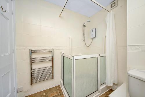 a bathroom with a shower and a toilet at Finest Retreats - Kilburn Hall Apt in Thirsk