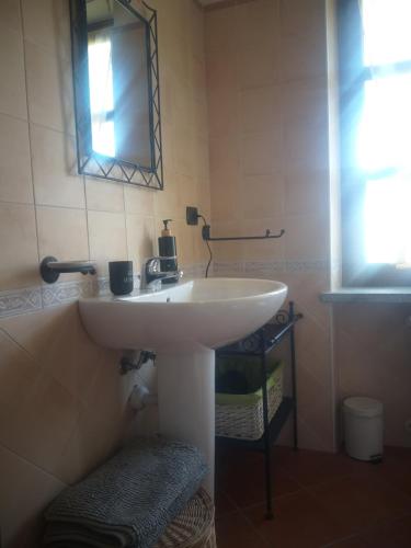 a bathroom with a white sink and a mirror at Mosci's Bed & Beer in San Damiano dʼAsti