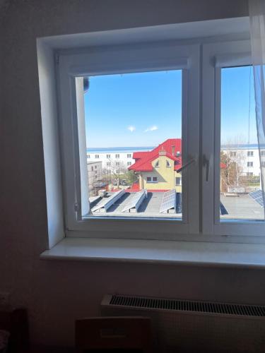 a window with a view of a building at Szyper in Jastarnia