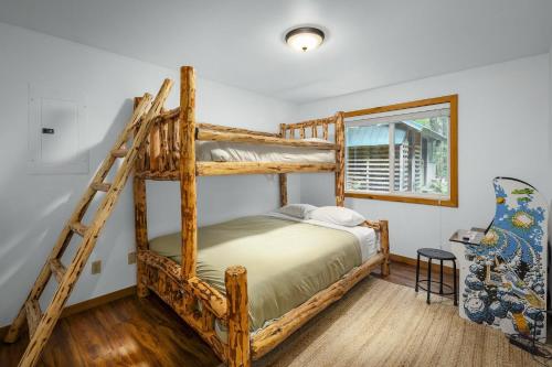 a bedroom with two bunk beds and a ladder at Sky One in Skykomish