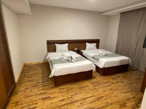Voodi või voodid majutusasutuse Miramar Evergreen Hotel toas