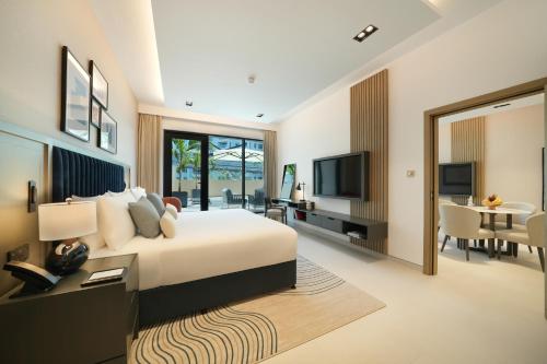 a hotel room with a bed and a living room at Cheval Maison - The Palm in Dubai