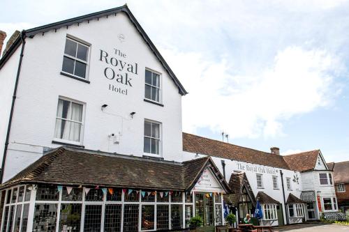 a white building with a sign for the royal oak hotel at The Royal Oak in Hawkhurst