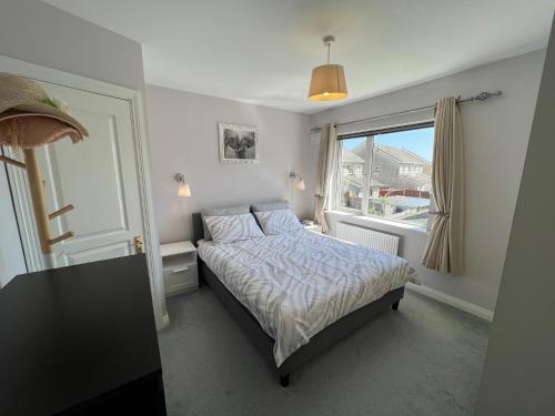 a small bedroom with a bed and a window at Adaline House Dublin in Dublin