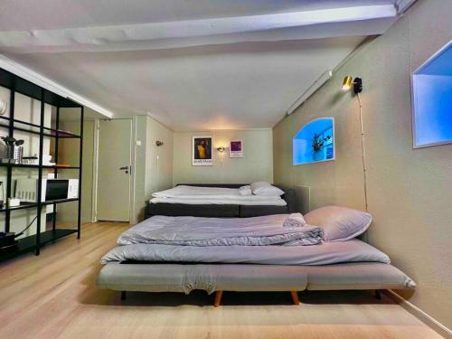a room with two beds and a desk in it at The Green Door H1 in Stavanger