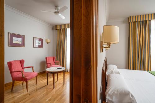 Cama o camas de una habitación en Hotel Hernán Cortés