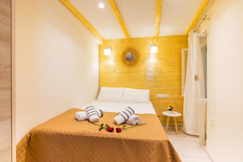 a bedroom with a bed with two towels on it at Olimpias Nest Corfu in Corfu