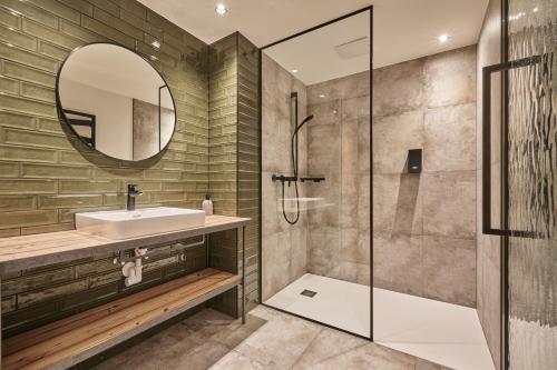 a bathroom with a sink and a shower at Alpendorf Hotel Stern in Sankt Johann im Pongau
