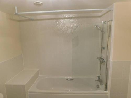 a shower with a glass door in a bathroom at AMILA House Manchester, Modern, Spacious, Sleeps 7 With Parking in Manchester