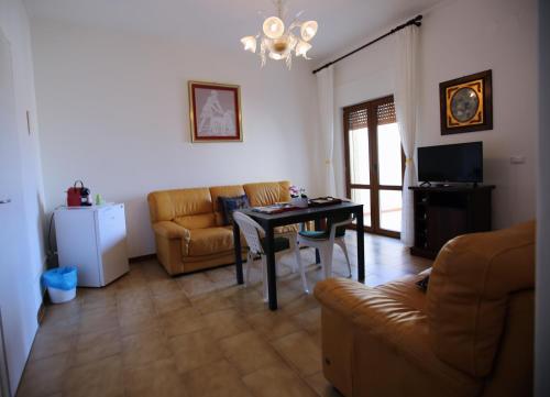 a living room with a couch and a table at Al Centro in Gangi