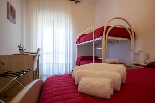 a bedroom with two bunk beds and a red rug at Al Centro in Gangi