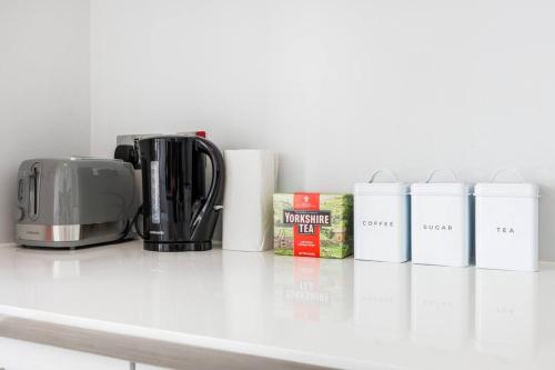 a kitchen counter with a toaster and a coffee maker at Charing Cross Road One Bedroom in London