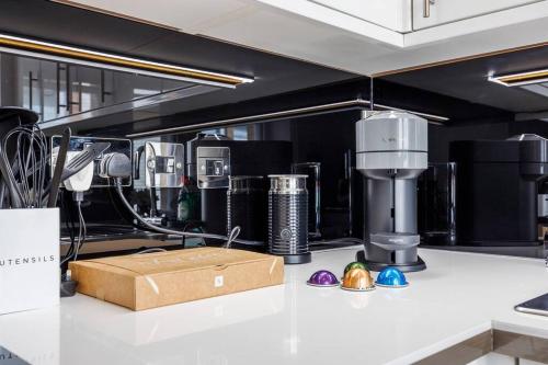 a kitchen counter with a coffee maker and a box at Charing Cross Road One Bedroom in London