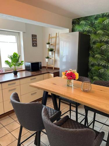 a kitchen with a table with chairs and a refrigerator at Fewo an der Stever in Lüdinghausen