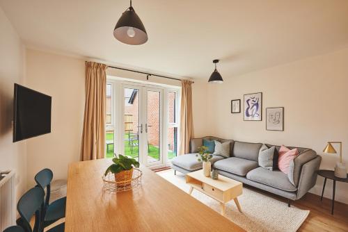 a living room with a couch and a table at Coventry Home for 6+2, 150Mbp Wi-Fi + Parking in Canley