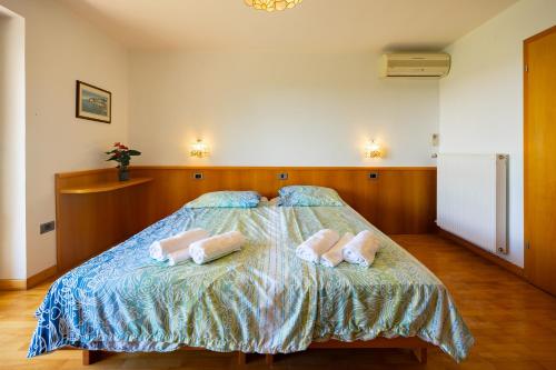 a bedroom with a bed with two pillows on it at Old Road Rooms and Apartments with Pool in Portorož