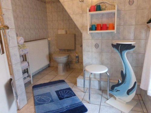 a toy bathroom with a toilet and a stool at westerwarft-10 in Büsum