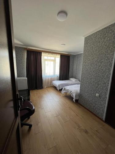 a hotel room with two beds and a window at Art Palace in Akhaltsikhe