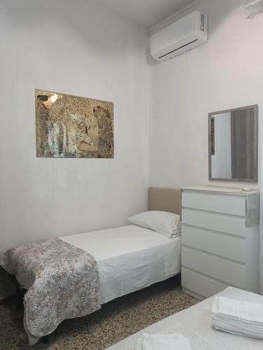 a bedroom with a bed and a dresser and a mirror at Bibbona Summer - Pineta 1 - in Marina di Bibbona