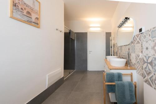 a bathroom with a sink and a mirror at Giardino del Borgo Appartamento Valpolicella in SantʼAmbrogio di Valpolicella