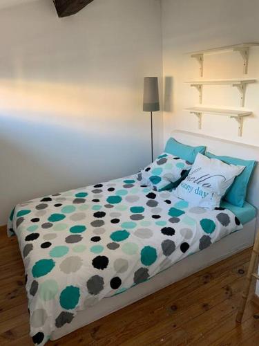 une chambre avec un lit avec une couette dessus dans l'établissement T2 Centre Ville Tout Confort, à La Ciotat