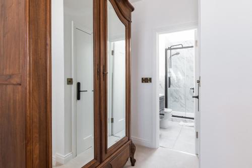 a large wooden mirror in a bathroom with a toilet at Number 59 Dublin in Dublin