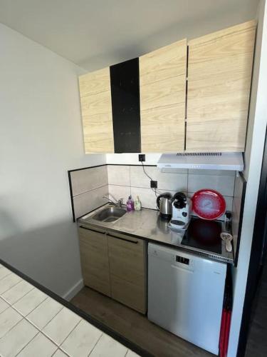 Il comprend une petite cuisine équipée d'une cuisinière et d'un évier. dans l'établissement Joli Studio Cabine 1ère ligne avec parking privé, à Palavas-les-Flots