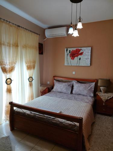 a bedroom with a large bed and a window at Christina's Home in Sarti
