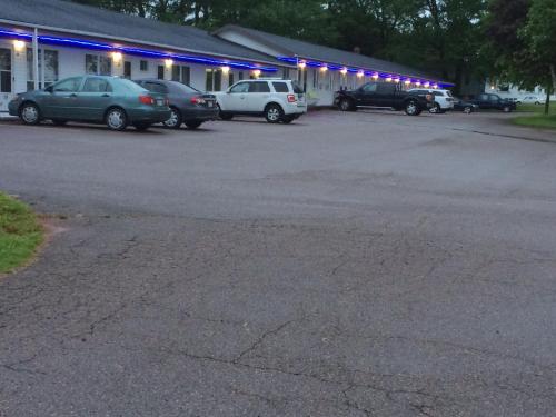 a parking lot with cars parked in front of a building at Carleton Motel and Coffee Shop in Borden-Carleton