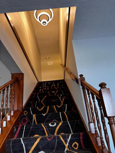 a stairway with a carpet and a ceiling at Sky Lodge Inn & Suites - Delavan in Delavan