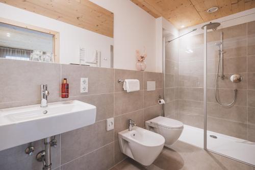 a bathroom with a toilet and a sink and a shower at Residence Nives in Bressanone