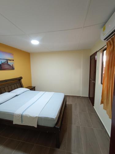 a bedroom with a bed in a room at Hotel Costa mar in Barranquilla