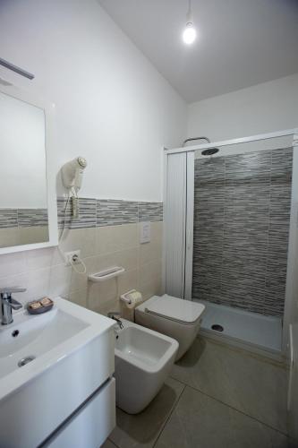 a bathroom with a sink and a toilet and a shower at Nonno Giovanni in Gangi